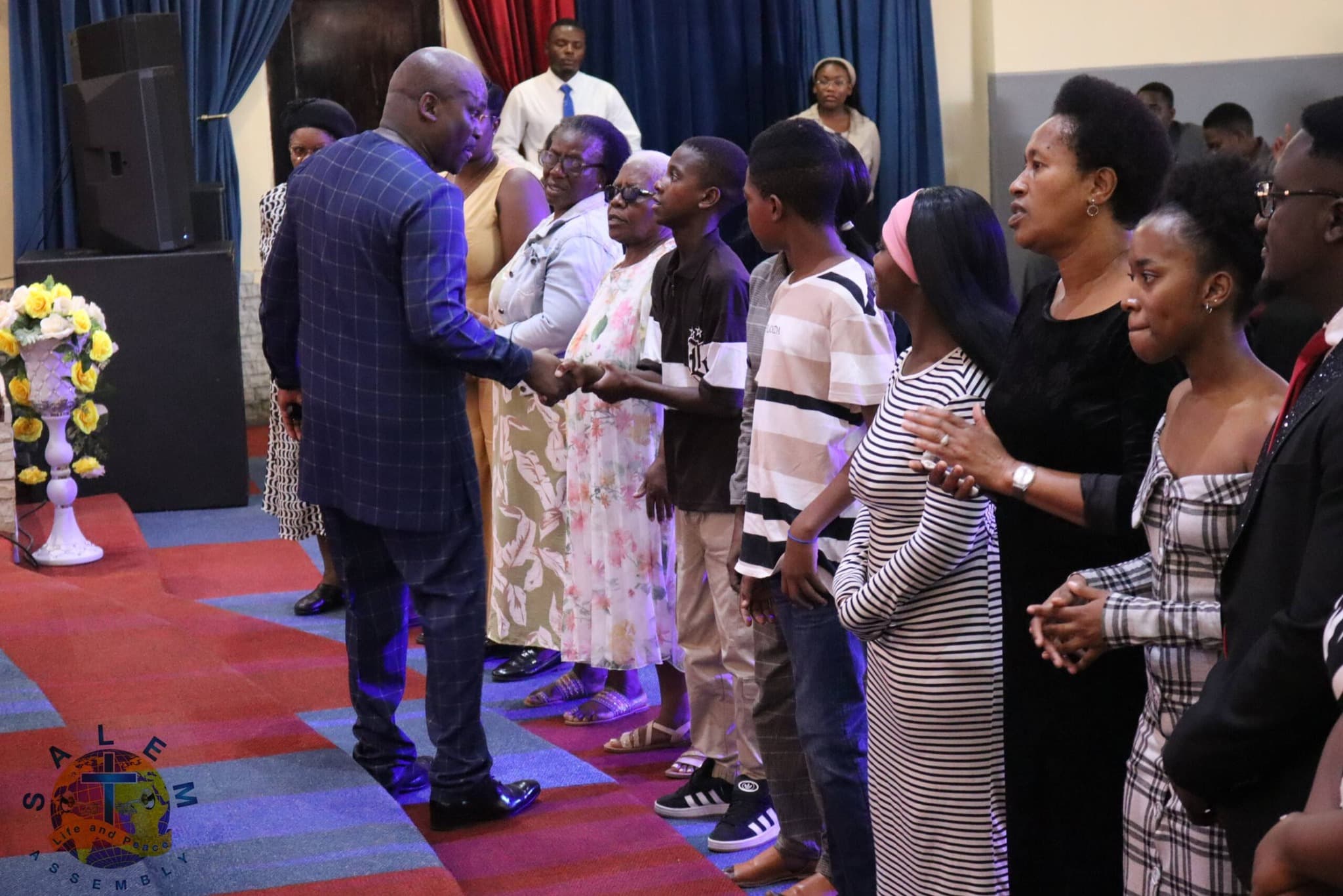 Pastor greeting congregation